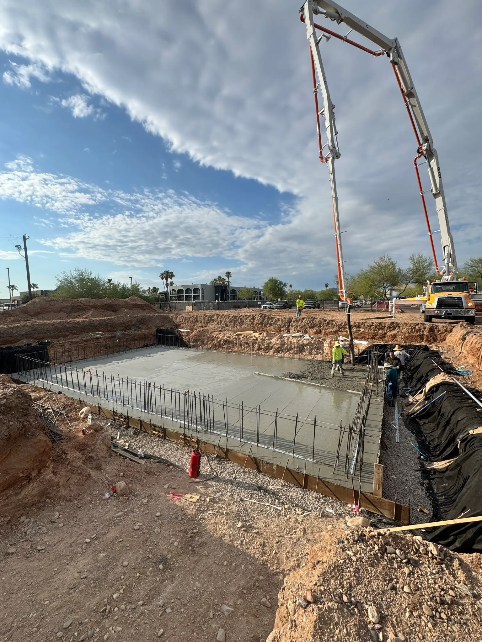 Pump truck pour with dramatic sky by Valley Con LLC